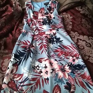 A kids  sky blue dress covered with flowers